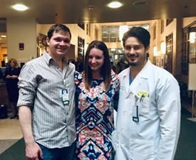 Jacqui flanked by surgical residents Thomas Crosslin, MD (left) and Michael Blea, MD who cared for her during her stay